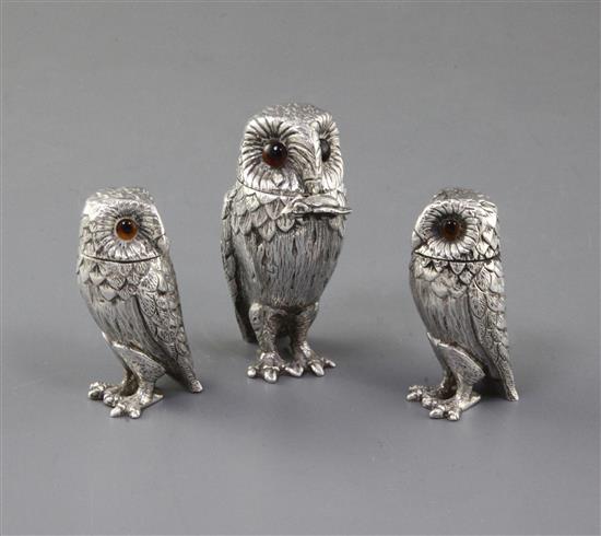A 1960s silver three piece condiment set modelled as owls, by William Comyns & Sons Ltd, mustard 75mm.